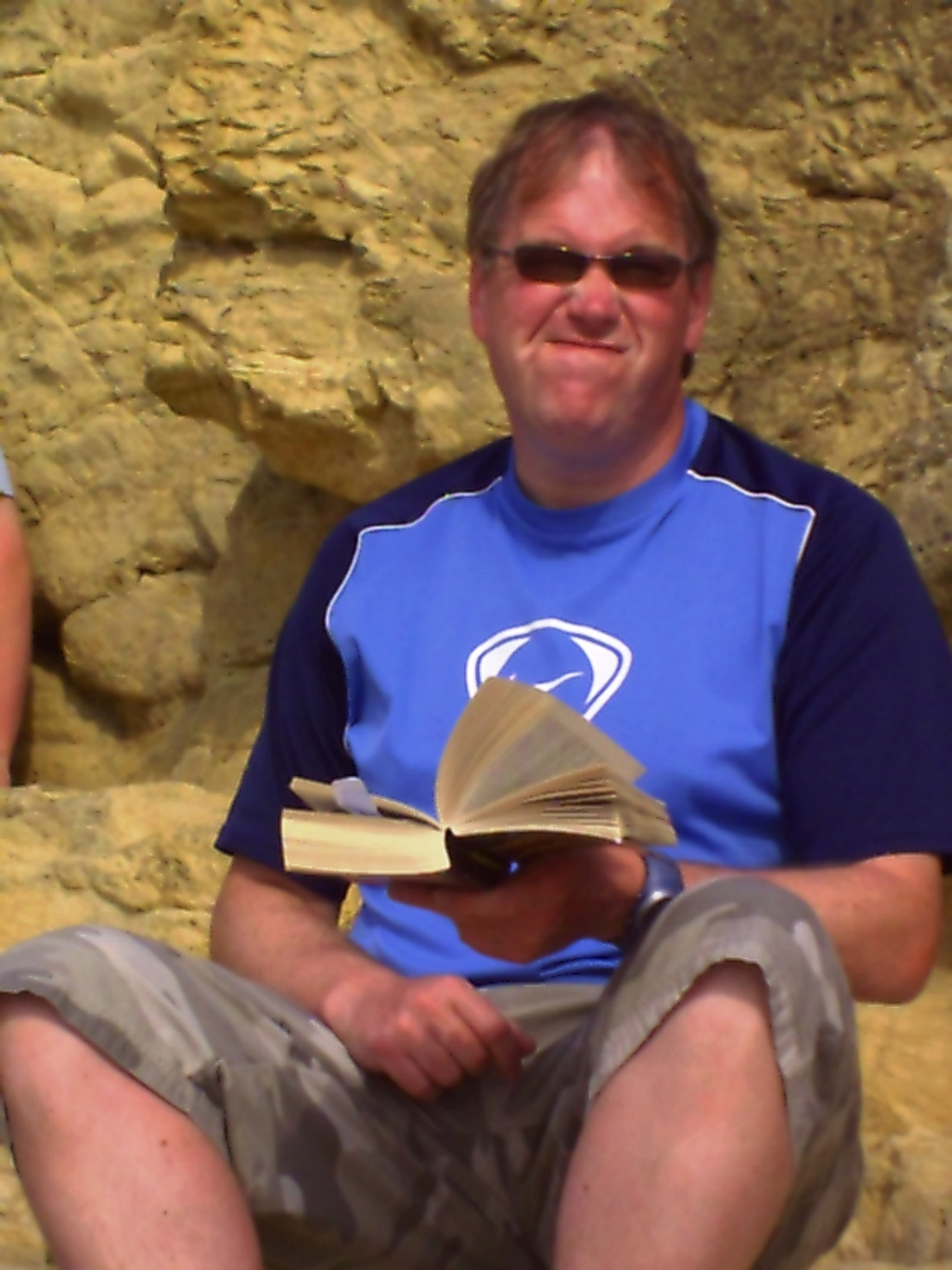 Paul reading sort of on Church Bay Beach, Anglesey